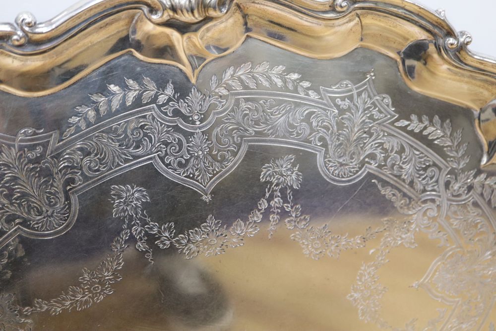 A large shaped oval silver two-handled tray with shell and scroll border, approx 116oz